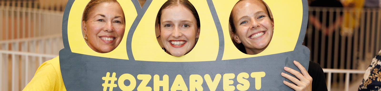 Suncorp bank staff with ozharvest sign