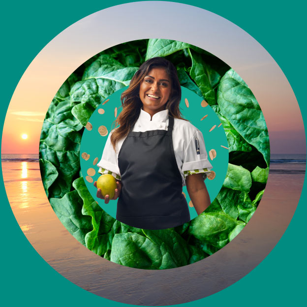 Woman wearing a chef's apron holding a mango