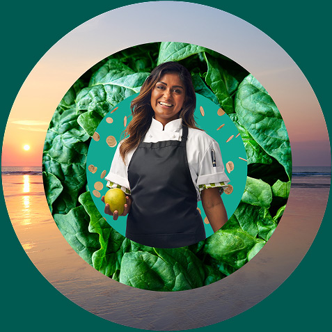 Woman wearing a chef's apron holding a mango