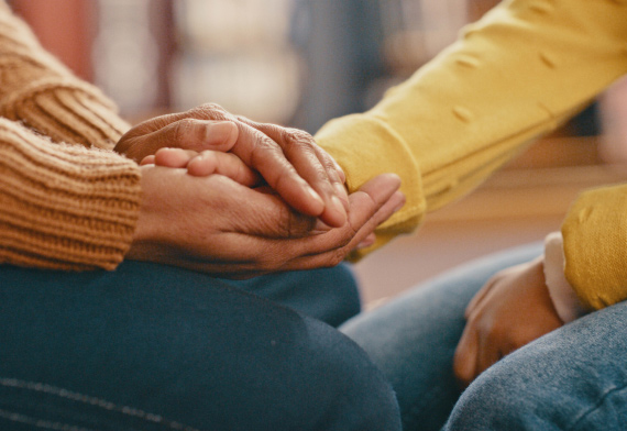 Two people holding hands