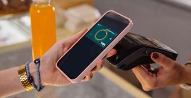 A Suncorp Bank customer using contactless payment at a cafe