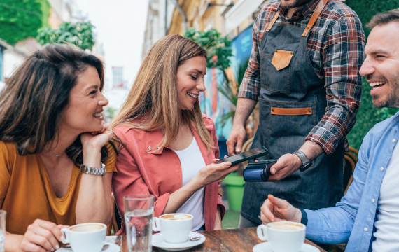 Women using smartphone to pay