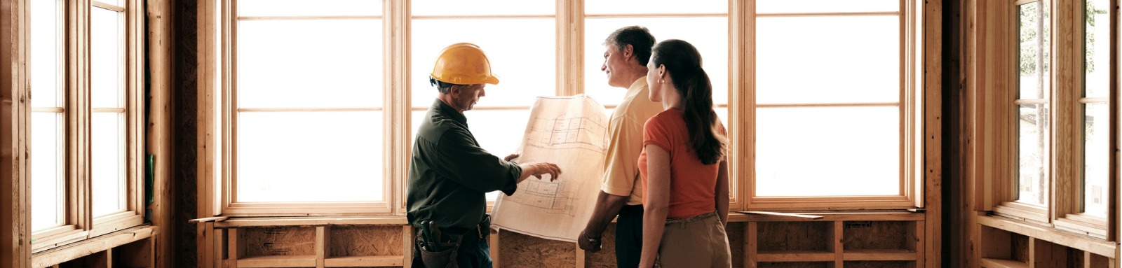 Couple discussing house construction with builder